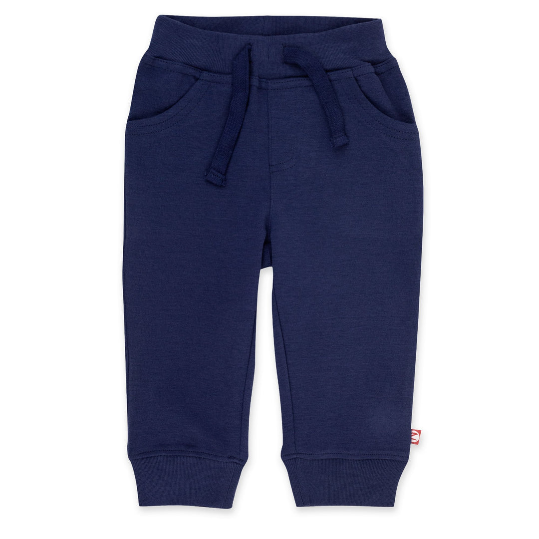 Navy blue organic cotton jogger pants for babies, showing the front view with pockets and drawstring waist.