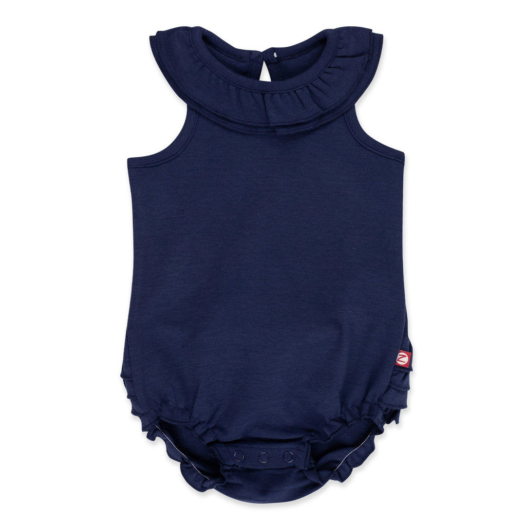 A navy blue organic cotton ruffle romper for babies with a ruffled collar and bottom, keyhole opening at the back, and snaps between the legs.