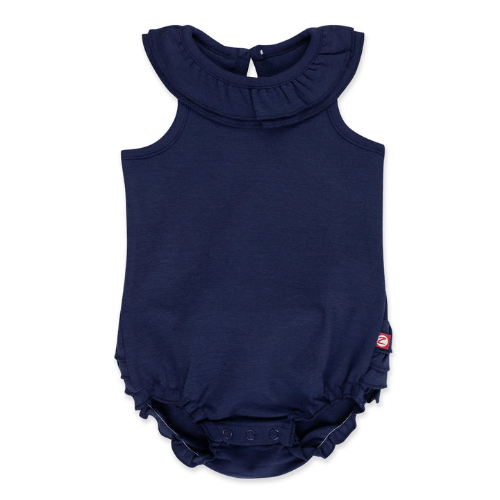 A navy blue organic cotton ruffle romper for babies with a ruffled collar and bottom, keyhole opening at the back, and snaps between the legs.