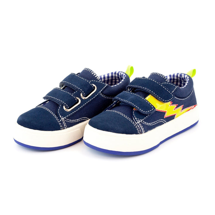 A pair of navy children's sneakers with a flame design on the side, featuring a padded collar, two-strap hook and loop closure, and a high-traction rubber outsole.
