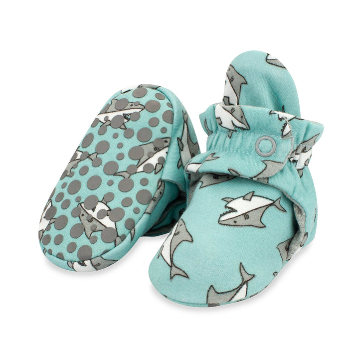 Organic cotton baby booties with a Baby Sharks print in blue and gray colors, featuring rubber grippers on the soles.