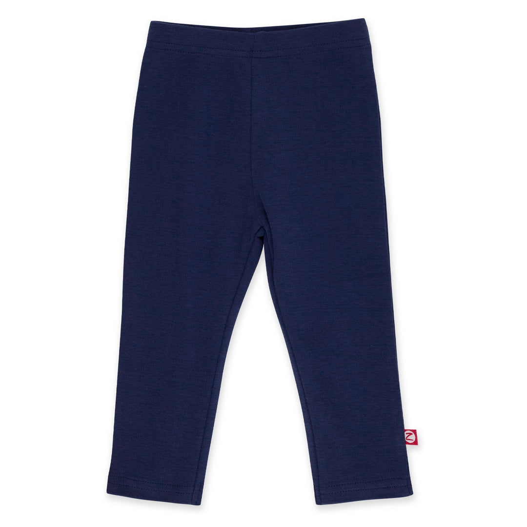 A pair of navy-colored organic cotton leggings for kids, with a visible brand tag on the lower right side.