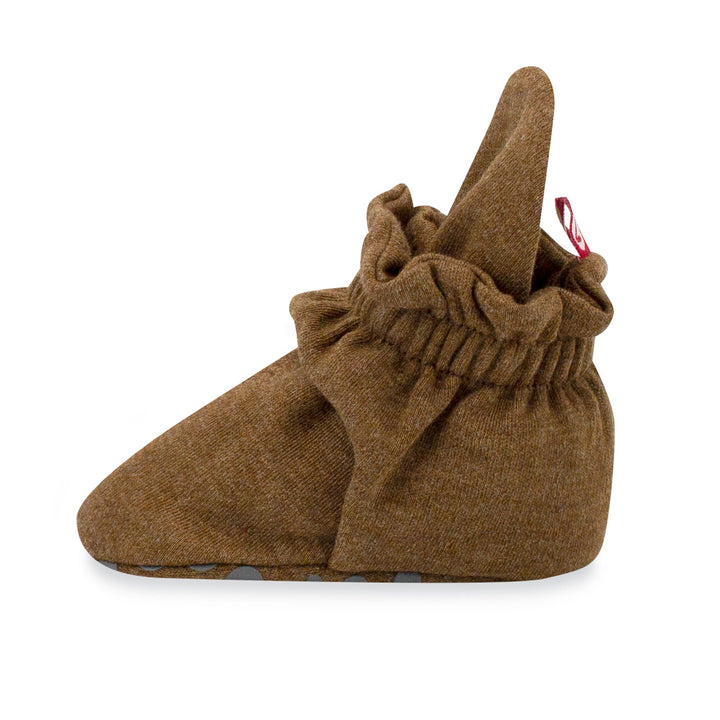 Pair of brown organic cotton baby booties with rubber grippers on the bottom, displayed against a white background.