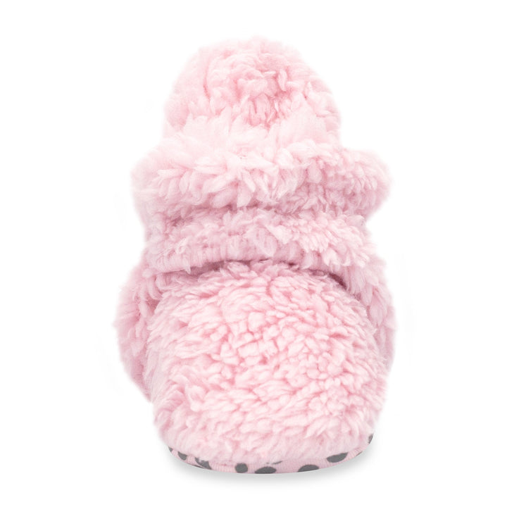 Pink baby booties with faux fur exterior and gripper soles, displayed against a white background.