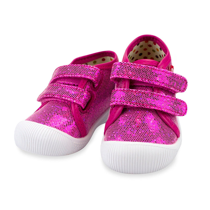 A pair of pink baby sneakers with a hook & loop strap and a sparkly azalea color finish.