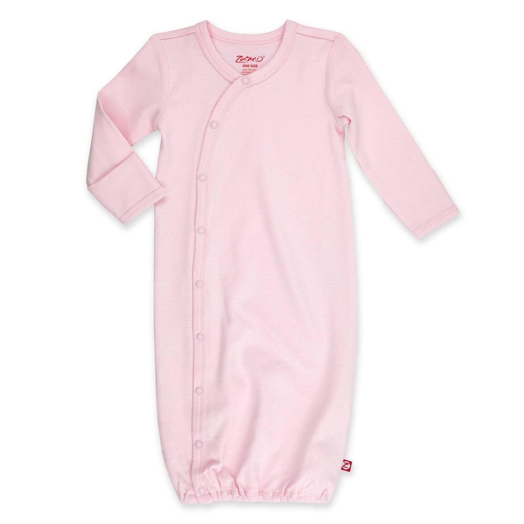 A pink organic cotton baby kimono gown with fold-over mitts on the sleeves and snaps down the front.