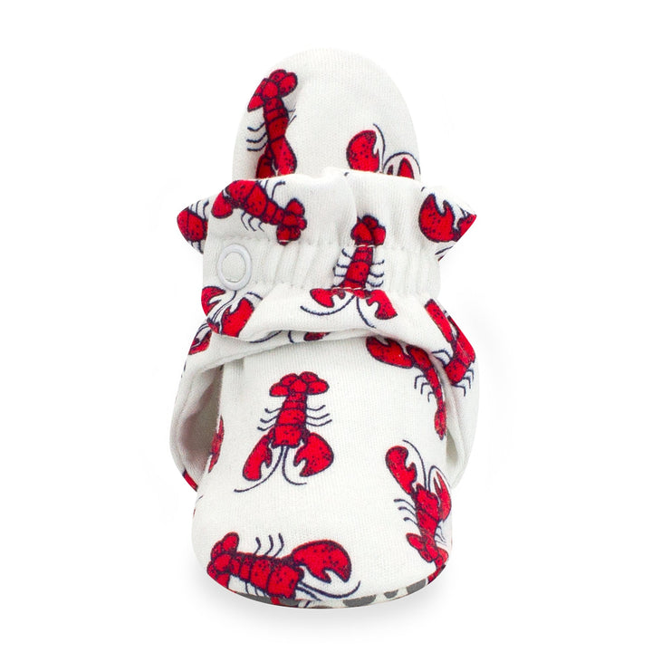 Baby booties with a red lobster print and gray dots, featuring rubber grippers on the bottom.
