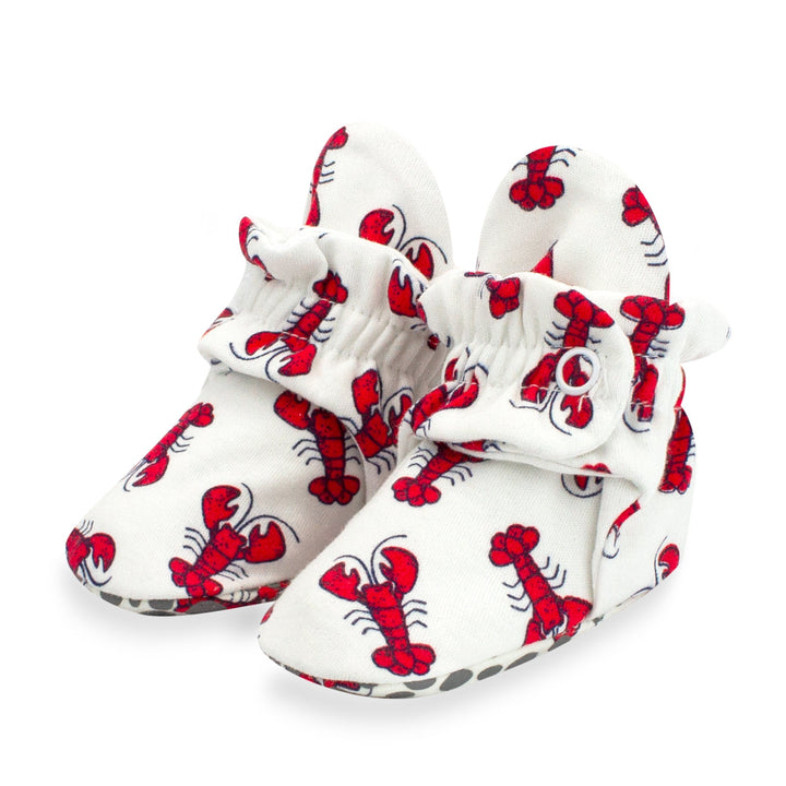Red lobster print baby booties featuring rubber grippers on the bottom.
