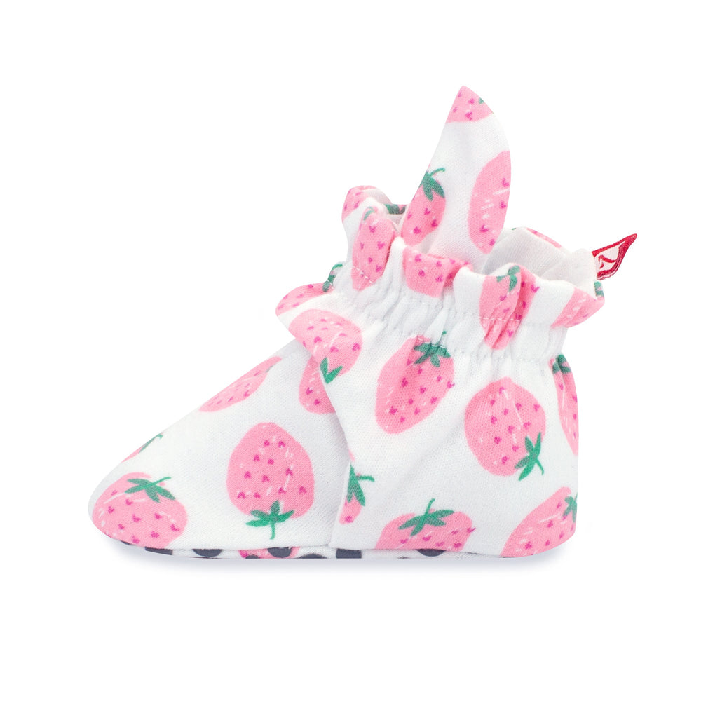 Set of pink baby booties with a strawberries print and rubber grippers on the sole.
