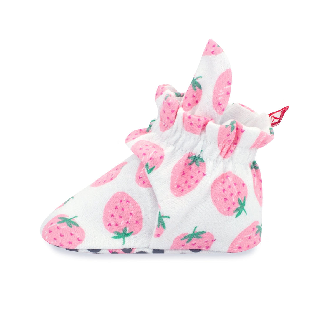 Set of pink baby booties with a strawberries print and rubber grippers on the sole.