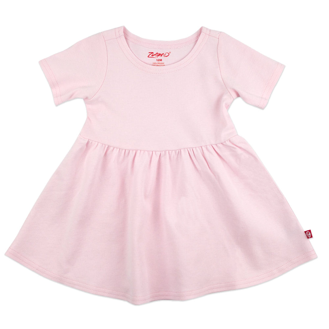 A short-sleeved baby pink dress made of organic cotton, designed for infants.