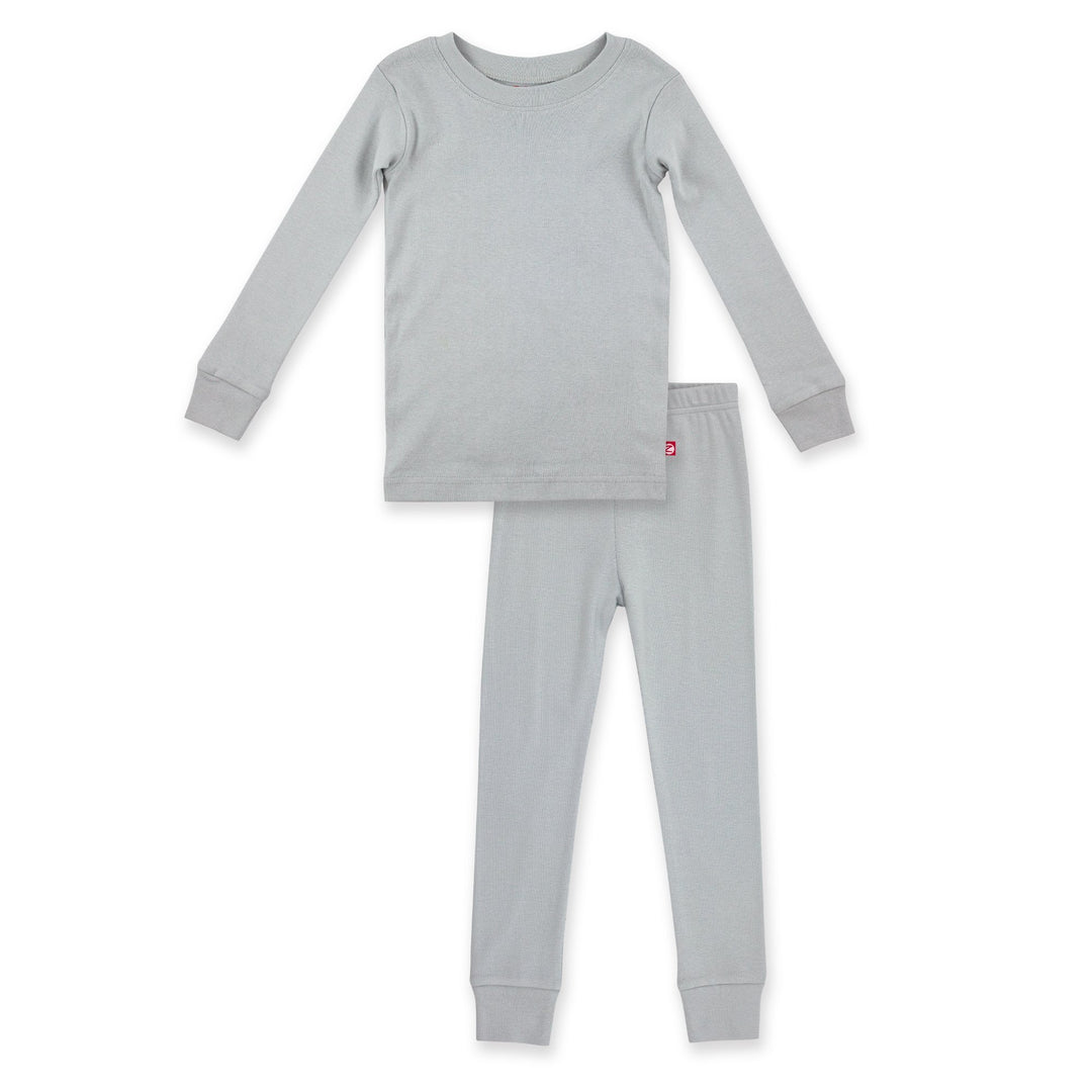 A two-piece organic cotton pajama set for children in light gray, including a long-sleeve top and matching pants with rib cuffs and an elastic waistband.