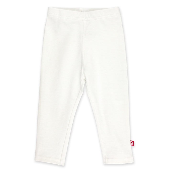A pair of white organic cotton leggings for babies, with a visible red label on the lower right leg.