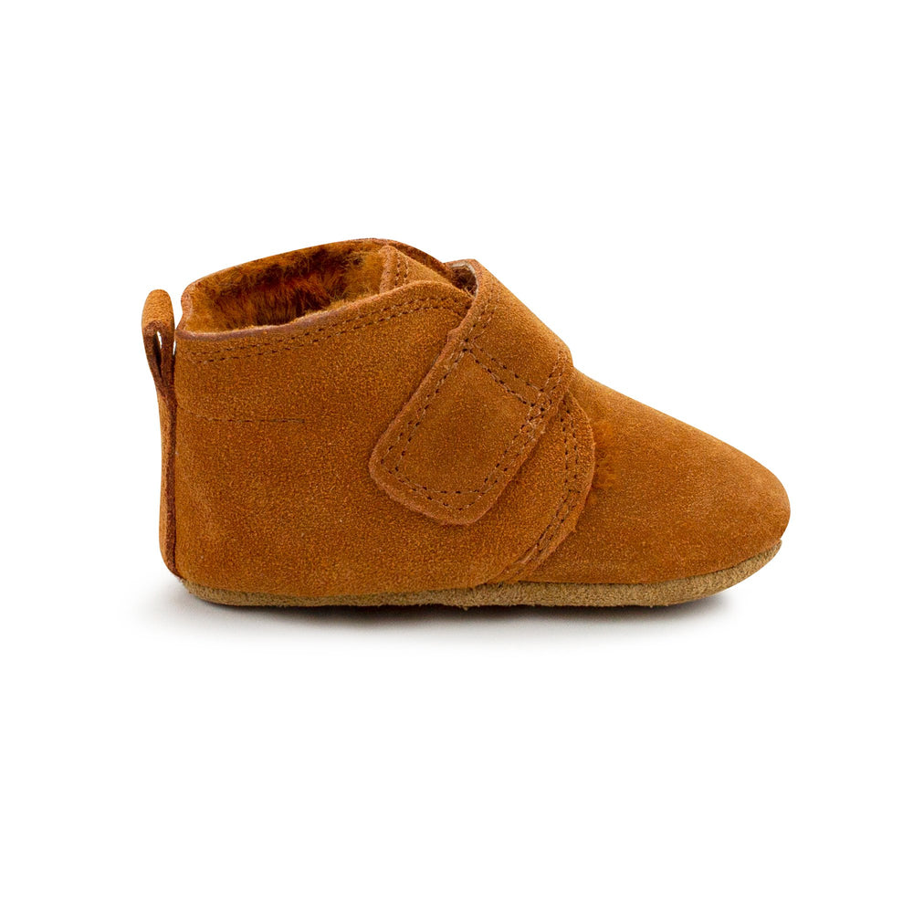 Pair of brown baby shoes with furry lining and a Velcro strap across the front.