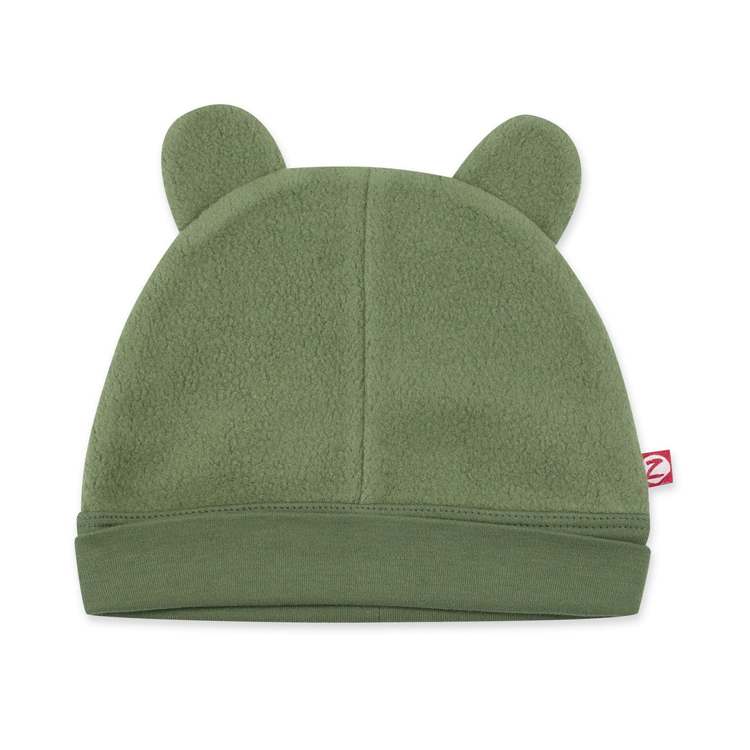 A green fleece baby hat with ears resembling a bear's face.