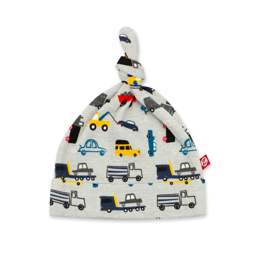 Organic cotton baby hat with a knot on top and a print of various vehicles.