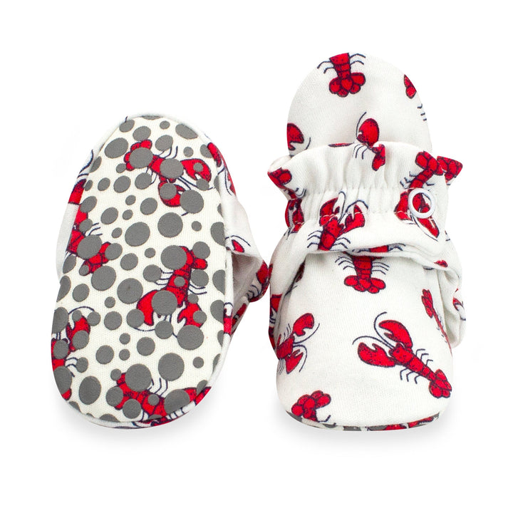 Red lobster print baby booties featuring rubber grippers on the bottom.
